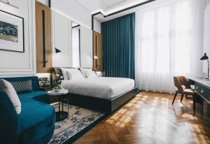 Yangon Excelsior gay-friendly hotel room. Luxurious interior with bed, couch, desk, and stylish decor. Ideal for gay travelers' comfort.