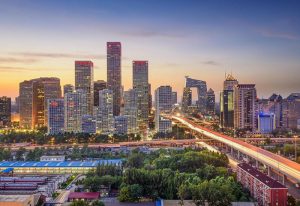 Beijing skyline at dusk near Ibis Beijing Tuanjiehu, a gay-friendly hotel. Cityscape view with modern buildings and vibrant lights.