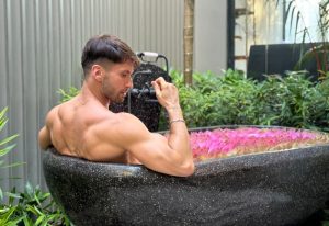 Gay man relaxing in a private pool villa at Shinta Mani Angkor. Bensley Collection Pool Villas in Siem Reap offer luxury travel for gay men.