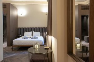 Athens 1890 Hotel bedroom. Gay-friendly adults-only hotel room with king bed, modern decor, and spa bathroom. Luxury travel in Athens.