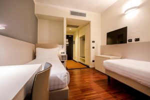 43 Station Hotel room. Gay-friendly hotel with two single beds, desk, TV, and closet. Modern design, comfortable for gay travelers.