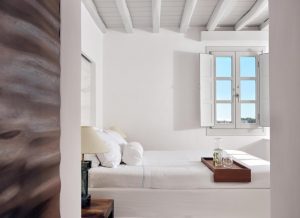 Belvedere Mykonos Hotel room. Minimalist white suite with tray on bed. Gay-friendly hotel rooms & suites in Mykonos, Greece.
