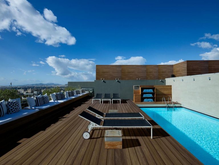 Rooftop pool at Fresh Hotel, a gay-friendly hotel. Deck chairs, seating, and towels are available. Perfect for gay men's travel.