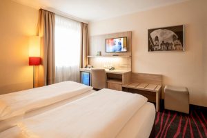 Hotel Europäischer Hof's gay-friendly room. Two beds, desk, TV, mini-fridge. A comfortable stay for gay travelers.