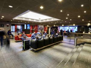 Ibis Milano Centro Hotel lobby. Guests relax in the gay-friendly hotel's modern lounge area with sofas and reception desk.