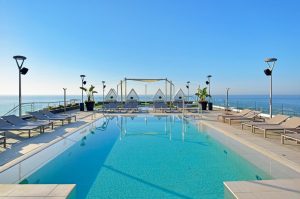Melia Costa del Sol gay-friendly hotel rooftop pool. Lounge chairs, cabanas, and ocean views. A perfect gay travel destination.