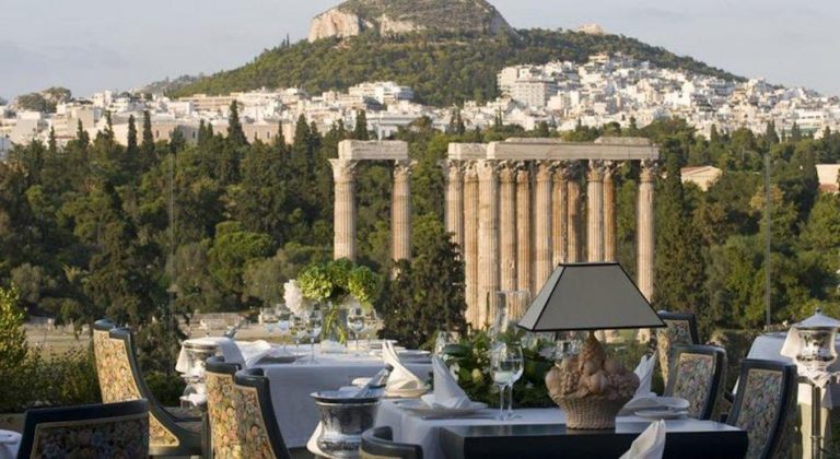 Royal Olympic Hotel gay-friendly view. Temple of Zeus and Athens cityscape seen from rooftop restaurant. Gay travel advice for Athens.