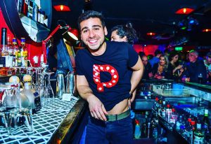 Pantibar, Dublin's best gay bar. Smiling man in Pantibar T-shirt at the bar. Gay Dublin travel guide, nightlife, and gay scene.