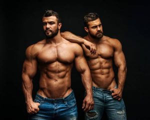 Two muscular gay men in jeans. Tantric Soul Gay Massage London, gay massage spa.