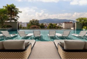 Chiang Mai Marriott Hotel rooftop pool view. Best gay Marriott Bonvoy hotel with loungers overlooking city and mountains. Gay travel advice.