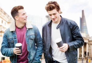 Gay couple at Andaz London Liverpool Street, a Shoreditch hotel. Two men with coffee in London. Best LGBT hotels near Liverpool Street.