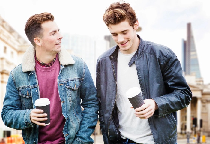 Gay couple at Andaz London Liverpool Street, a Shoreditch hotel. Two men with coffee in London. Best LGBT hotels near Liverpool Street.