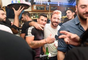 Santorini gay nightlife at 2 Brothers Bar. Gay travelers enjoy drinks. The bar's lively atmosphere makes it a top destination this year.