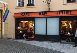 Café Bar Flirt in Prague, a gay-friendly travel destination. Rainbow flag, balloons, and men inside. A popular spot for gay men to flirt.