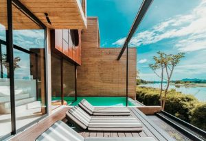 Cross-river hotel for a weekend away from Bangkok. Modern architecture, pool, and river view. Best gay hotels for Thailand travel.