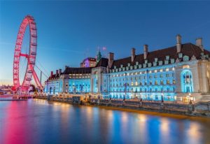 London Marriott Hotel County Hall at night. Luxury gay hotel on the River Thames with the London Eye.