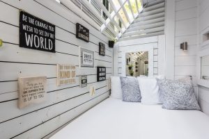 Alexander's Guesthouse gay-friendly hotel: Stylish white daybed with pillows and inspirational wall art. A relaxing space for gay travelers.