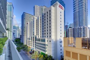 Hampton Inn & Suites Miami/Brickell-Downtown, a gay-friendly hotel. High-rise building with palm trees in Miami's Brickell neighborhood.