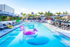 Moxy Miami South Beach hotel pool with unicorn float. Gay-friendly travel destination, perfect for LGBTQ+ vacations. Relaxing South Beach vibes.