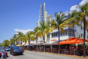 Breakwater Hotel South Beach facade. A gay-friendly hotel with Art Deco architecture, palm trees, and outdoor dining in Miami Beach.