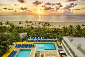 Royal Palm South Beach Miami, a gay-friendly hotel. Ocean view at sunset from this Tribute Portfolio Resort, pool and beach with palm trees.