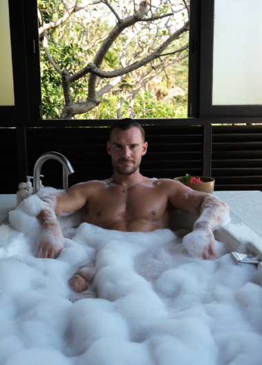 Steven in a bubble bath at Garrya Tongsai Bay, Koh Samui, Thailand. One of Steven and Manu's Top 5 hotels for gay men travel.