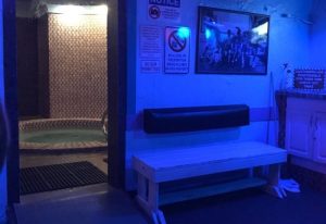 Club Aqua interior. Hot tub room with tiled walls, bench, and signs. Gay travel advice for finding the best gay sauna and cruise club. 4-17.jpg