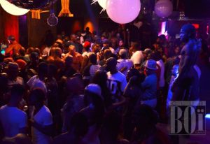 Crowded scene at Club Boi, Miami's gay nightlife spot. Shirtless dancers and partygoers under disco lights create a vibrant atmosphere. 5-15.jpg
