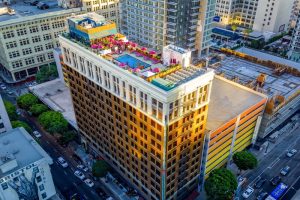 Freehand Los Angeles, a gay-friendly hotel. Rooftop pool and bar with pink umbrellas. Urban hotel in downtown LA.