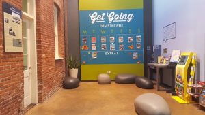 HI Los Angeles Santa Monica Hostel interior. Gay-friendly hotel with event calendar, info kiosk, and brick wall. Great for gay travel.