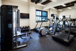 Hotel Figueroa's gym, a gay-friendly hotel in Los Angeles. Cardio machines, weights, and a multi-gym provide options for a full workout.