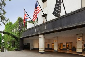 The London West Hollywood at Beverly Hills entrance. Gay-friendly hotel with flags. Luxury travel for gay men in West Hollywood, California.