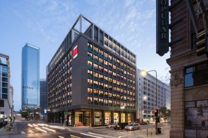 citizenM Los Angeles Downtown hotel exterior. Gay-friendly hotel architecture in LA. Modern design, street view, and city skyline.