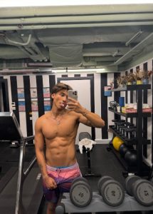 Shirtless man at Mama Shelter London Shoreditch gym. Hottest & cheapest gay hotels in London with gym. Gay travel advice.