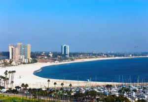 Gay Long Beach Travel Guide: Aerial view of Long Beach, CA, featuring the beach, ocean, marina, and city skyline. Number One Gay Travel destination.