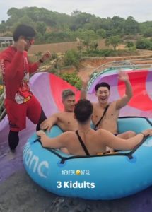 Renaissance Pattaya Resort & Spa: Gay men enjoying a water slide. Three shirtless men in a raft, plus a lifeguard. Fun travel image.
