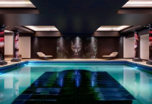 NYX Hotel London Holborn pool. Most popular gay hotel London features a swimming pool, lounge chairs, and a jaguar mosaic. Leonardo Hotels.