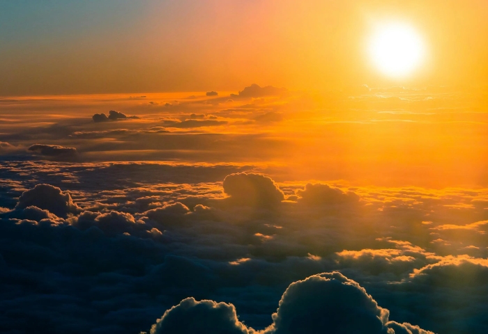 Golden sun above clouds, perfect sun break destination. Gay travel tips for planning your next vacation. Sun-kissed gay travel recommendations.