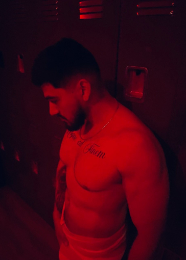 Gay Las Vegas: Man in a towel at a bathhouse. Red lighting, lockers. Best gay cruise clubs and bathhouses in Las Vegas travel guide.