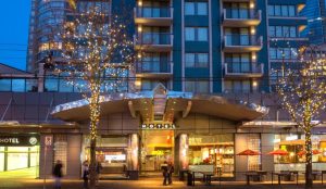 Blue Horizon Hotel, a gay-friendly hotel. Exterior view at dusk with trees decorated with lights. A great choice for gay travel.