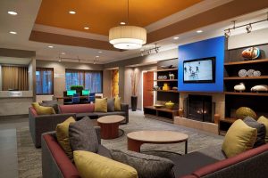 Courtyard by Marriott Toronto Downtown lobby. Gay-friendly hotel with lounge, TV, fireplace, and workspace. Modern interior design.