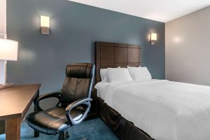 Econo Lodge hotel room. Gay-friendly travel lodging with a comfy bed, desk, and chair. A good choice for gay men's travel.