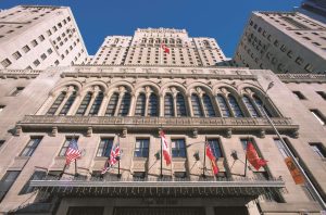 Facade of Fairmont Royal York, a gay-friendly hotel. Flags of different countries adorn the hotel's exterior. Toronto, Canada.