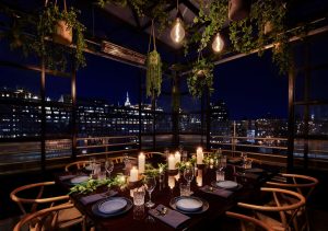 Gansevoort Meatpacking NYC gay-friendly hotel rooftop dining. Candles, greenery, and city views for a memorable experience.