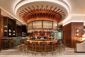 HONEYROSE Hotel Montreal bar. Gay-friendly Tribute Portfolio Hotel with circular bar, stylish lighting, and glasses. A great place to meet.
