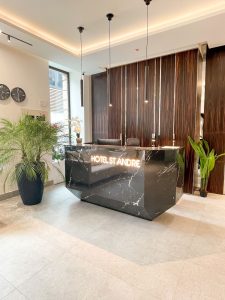 Hotel Saint-Andre's reception area. This gay-friendly hotel features a modern design with a marble desk and stylish lighting, welcoming gay travelers.