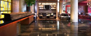 Ink 48 Hotel lobby interior. Gay-friendly hotel features stylish seating areas, modern design, and a welcoming atmosphere for LGBTQ+ travelers.