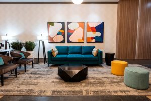 Sandman Suites Vancouver Davie Street lobby. Gay-friendly hotel with modern decor, colorful art, & comfortable seating. Great for gay travel.