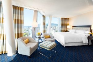 Sheraton Vancouver Wall Centre gay-friendly hotel room. Modern design, city view, comfortable seating, and a luxurious bed. Perfect for gay travel.