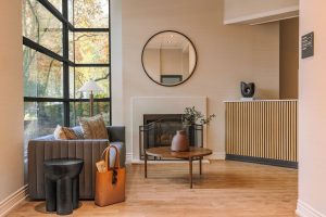 Sonder The Sunset lobby interior. Gay-friendly hotel with modern design, fireplace, seating area, and large windows. A comfortable, stylish space.